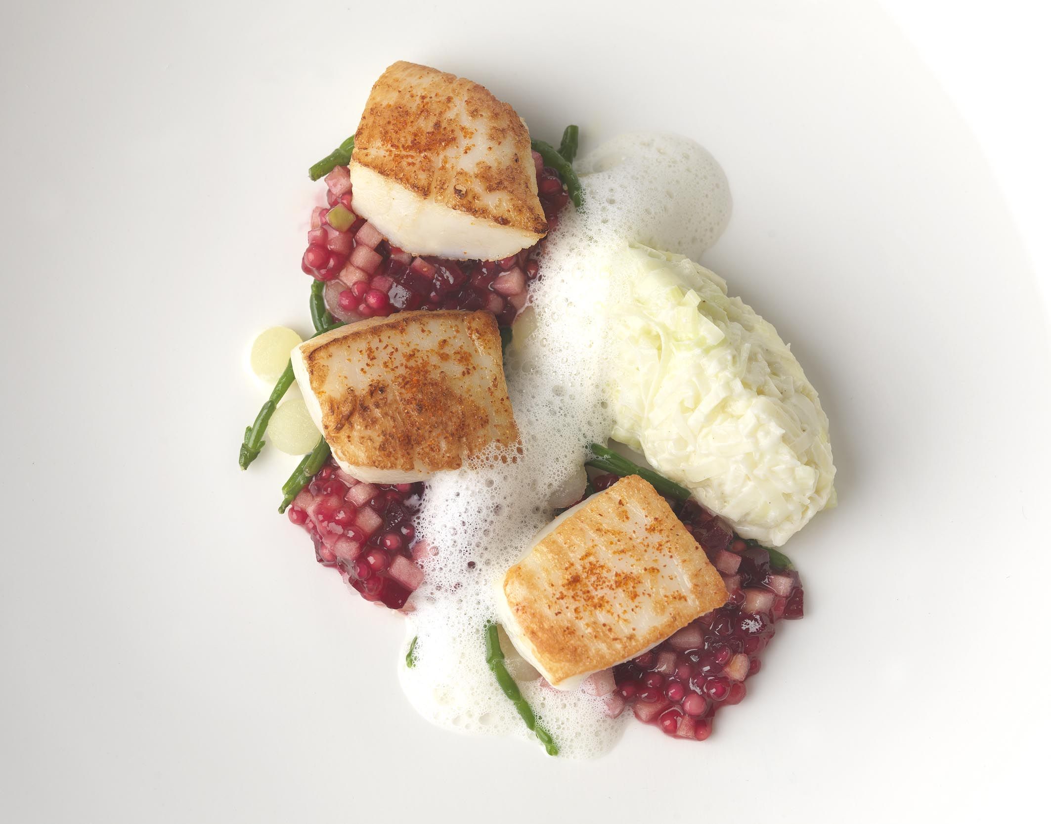 Pan roast hand dived scallops with scallop roe powder, creamed leeks, poached apple balls, beet and apple tapioca, cider foam and samphire