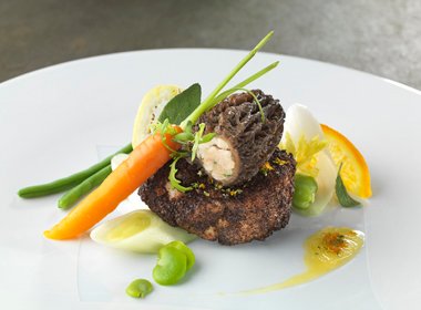 Fantasy of veal sweetbreads coated in morel mushrooms, fresh vegetables with citrus butter