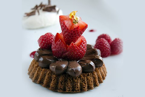 Chocolate genoa cake with creamy chocolate and berries