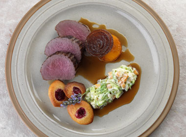 Loin of venison with cranberry Madeleines, creamed Savoy cabbage, roast onions and butternut squash, red wine jus